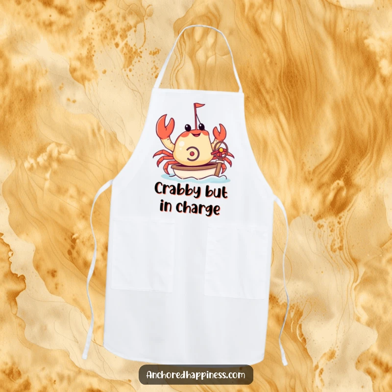 Funny apron featuring a crab attempting to steer a miniature yacht with its pincers. Humorous kitchen accessory for nautical-themed cooking. Great design.